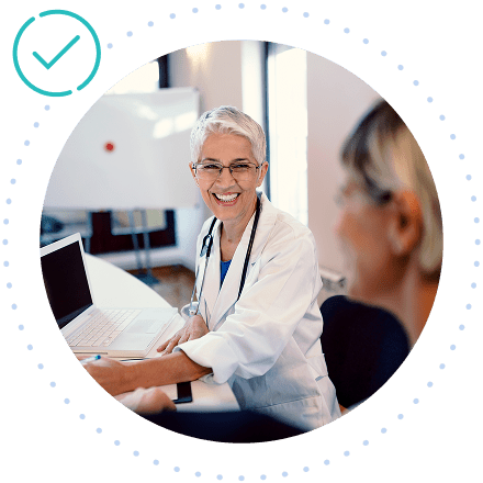 Veterinarian smiling while interacting with a consultant in a modern medical office.