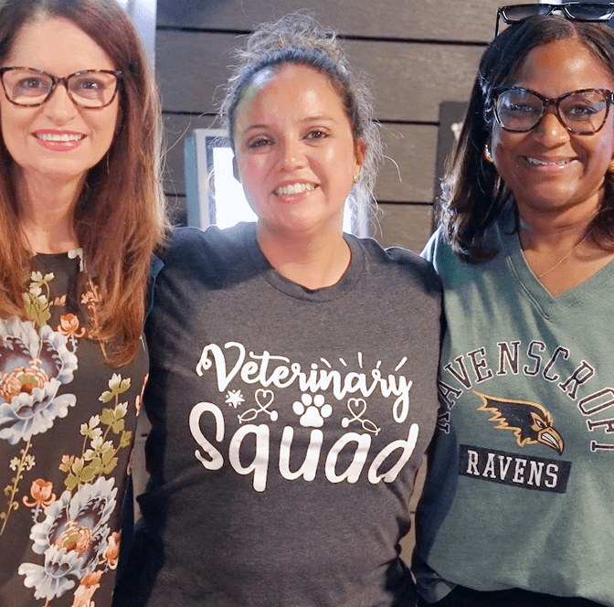 PSIvet Business Symposium 3 attendees smile while posing and looking into the camera