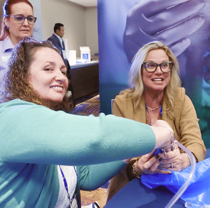 PSIvet Business Symposium attendees smile during a hands on demonstration